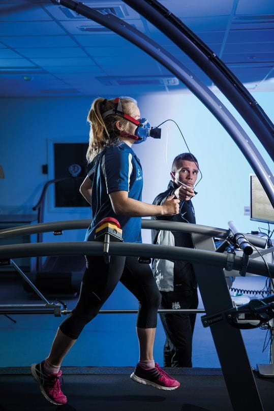 girl running on treadmill with gas analyser on
